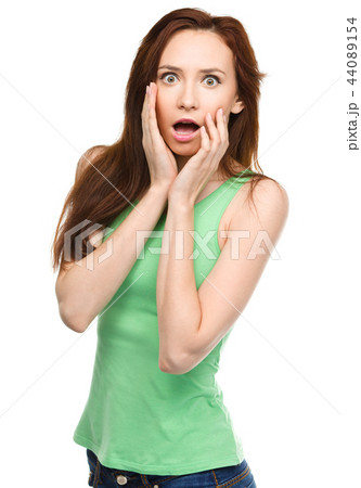 Woman is holding her face in astonishment Woman is holding her face in astonishment 44089154