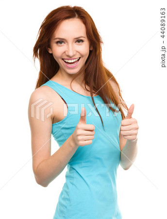 Woman is showing thumb up gesture Woman is showing thumb up gesture 44089163