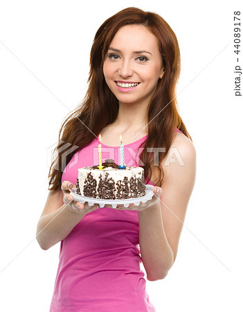 Young woman with anniversary cake Young woman with anniversary cake 44089178