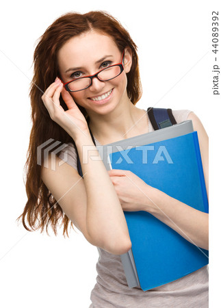 Young student girl is holding book Young student girl is holding book 44089392