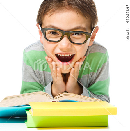 Astonished little boy is reading a book 44089897