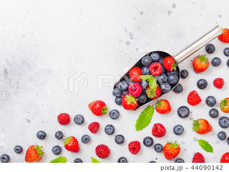 Fresh raw organic berries in steel scoop spoon Fresh raw organic berries in steel scoop spoon 44090142