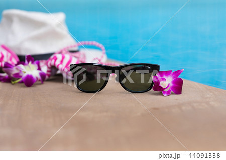 Sunglasses orchid flower and colourful swimwear 44091338