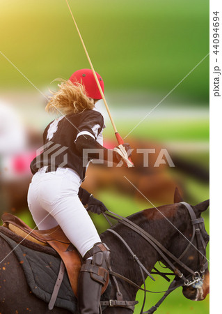 Polo woman player is riding on a horse. 44094694