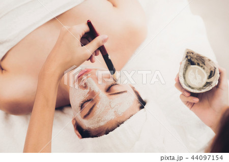 Beautiful woman having a facial treatment at spa. 44097154