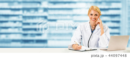 Pharmacist using laptop computer at pharmacy. Pharmacist using laptop computer at pharmacy. 44097448