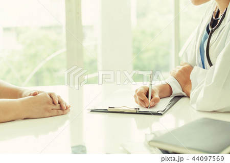 Woman Doctor and Female Patient in Hospital Office Woman Doctor and Female Patient in Hospital Office 44097569