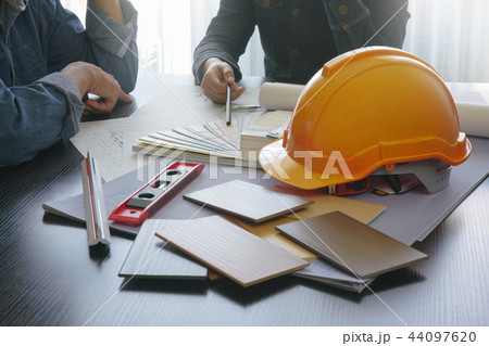 architect and engineer discussing on working table 44097620