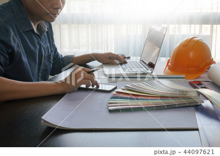 architect working on smartphone and laptop architect working on smartphone and laptop 44097621