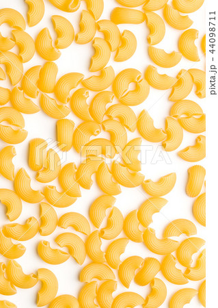 Uncooked elbow macaroni. Uncooked elbow macaroni. 44098711