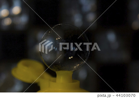 Soap bubble from neck of bottle, soft focus 44103070