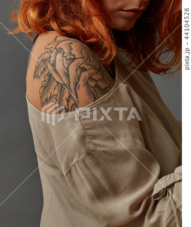 red-haired girl with a shoulder tattoo 44104526
