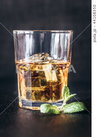 Glass of rum on the dark background 44108350