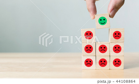 Hand picked wooden block with icon face emotion 44108864