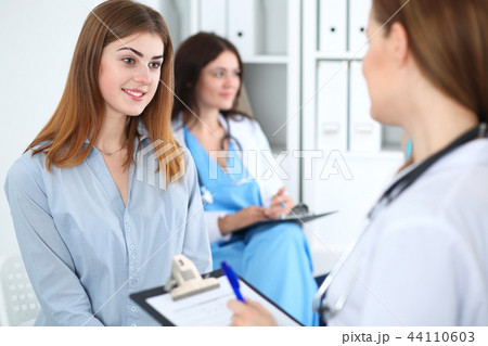 Happy smiling female patient with her doctor at clinic or hospital. Medicine and health care concept 44110603