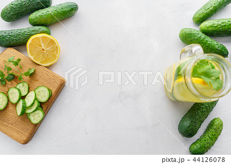 Summer cocktail cucumber lemonade. Refreshing water with cucumber, mint and lemon on grey background Summer cocktail cucumber lemonade. Refreshing water with cucumber, mint and lemon on grey background 44126078