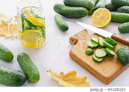 autumn leave. Summer cocktail cucumber lemonade. Refreshing water with cucumber, mint and lemon on 44126161