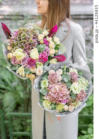 two beautiful spring bouquet. Young girl holding a flowers arrangements with various of colors 44126835