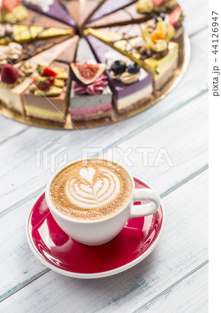 A cup of art coffee cappiciino and mini raw cakes 44126947