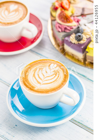 A cup of art coffee cappiciino and mini raw cakes 44126955