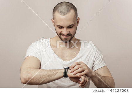 happy, joyful man is looking at the time 44127008