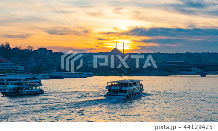 Tourist boat in Golden Horn Istanbul at sunset, Turkey Tourist boat in Golden Horn Istanbul at sunset, Turkey 44129425