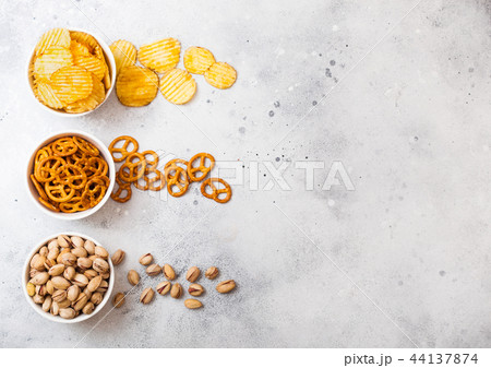 Pretzel and potato crisps and pistachio in white  44137874