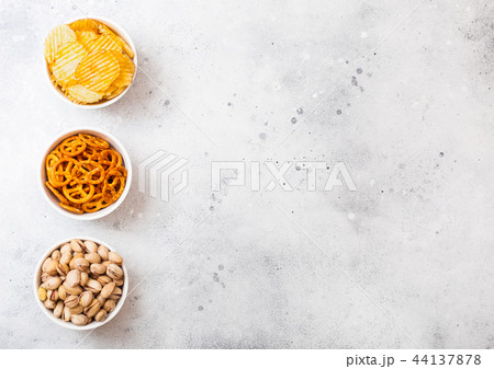 Pretzel and potato crisps and pistachio in white  44137878