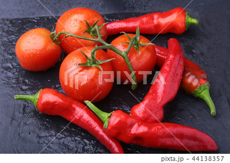 composition with chili pepper, cucumber and tomato close up 44138357