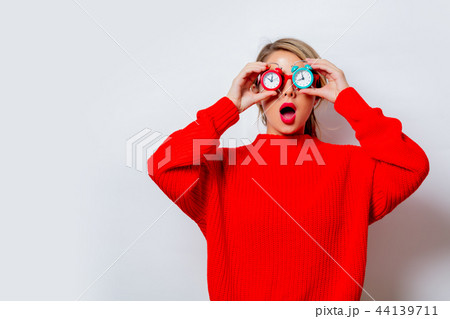 woman with alarm clocks on white background 44139711