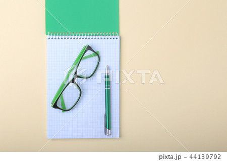 Business accessories on desktop: notebook, diary, fountain pen, glasses. Macro with blur and soft Business accessories on desktop: notebook, diary, fountain pen, glasses. Macro with blur and soft 44139792