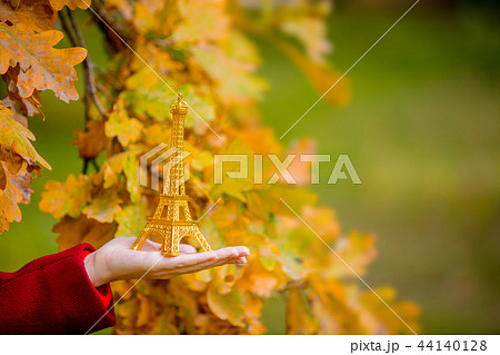 female hand holding an Eiffel tower toy female hand holding an Eiffel tower toy 44140128