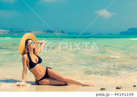 girl in black bikini and with hat on Balos beach girl in black bikini and with hat on Balos beach 44141149