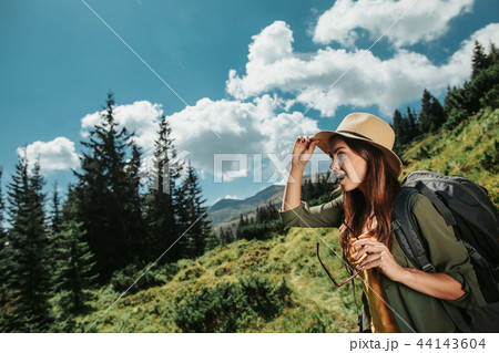 Young attractive lady with backpack observing forest landscapes 44143604