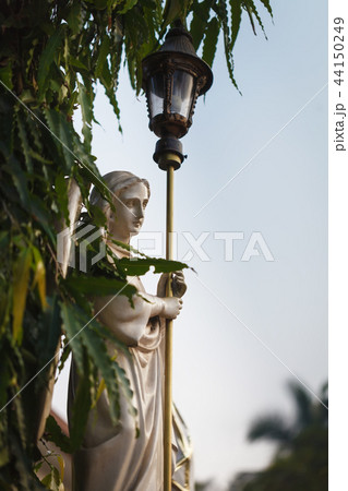 The angel with street lantern in dawn beams 44150249