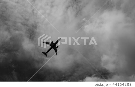 Commercial airplane on grey sky and clouds 44154203