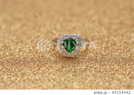 Heart green gemstone on diamond ring Heart green gemstone on diamond ring 44154542