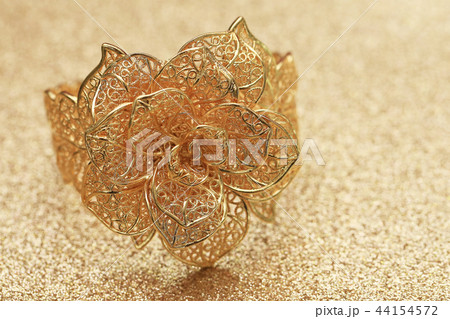 gold rose flower ring on glitter background 44154572