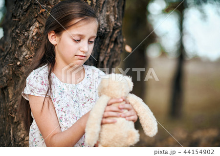 the girl child with toy bear is in the forest the girl child with toy bear is in the forest 44154902