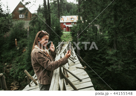 Beautiful girl waving hello to friend during video chat on smartphone 44155548