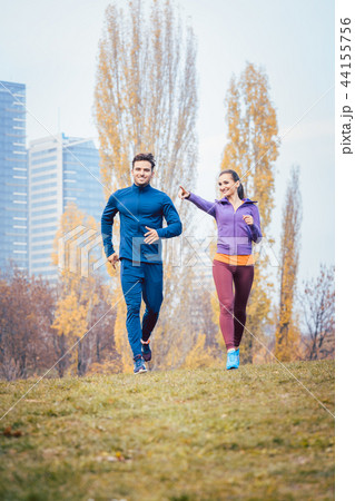Urban jogging - couple running in autumn city Urban jogging - couple running in autumn city 44155756