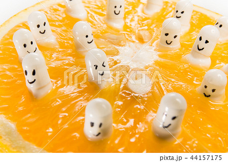 Funny capsules with vitamins from half an orange. Funny capsules with vitamins from half an orange. 44157175