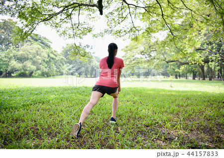 Exercise concept. Beautiful girl is stretching her muscles. Beau Exercise concept. Beautiful girl is stretching her muscles. Beau 44157833