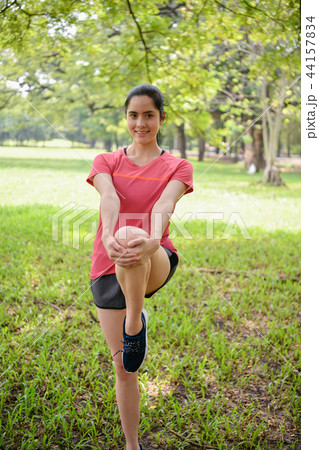 Exercise concept. Beautiful girl is stretching her muscles. Beau Exercise concept. Beautiful girl is stretching her muscles. Beau 44157834