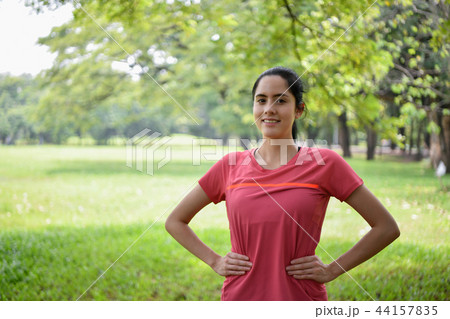 Exercise concept. Beautiful girl is stretching her muscles. Beau Exercise concept. Beautiful girl is stretching her muscles. Beau 44157835