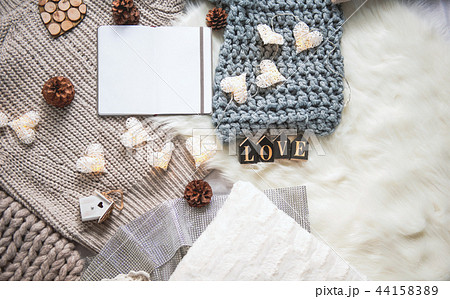 Sweater scarf and garland locating on carpet Sweater scarf and garland locating on carpet 44158389
