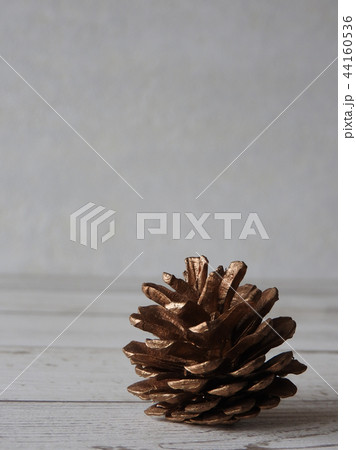 Golden color painted pine cone.Decorative object. 44160536