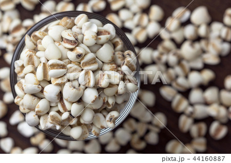Millet grain in glass cups on wooden close up.. 44160887