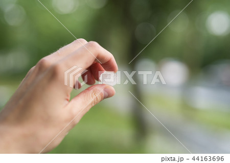 closeup male hand holding hailstones after hailstorm closeup male hand holding hailstones after hailstorm 44163696