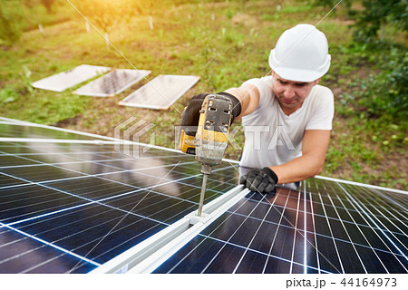 Installation of stand-alone exterior photo voltaic panels system. Renewable green energy generation. 44164973